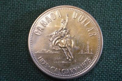Монета 1 доллар 1975 год. Елизавета II. Серебро. Калгари, 100 лет, родео. Canada, Канада.